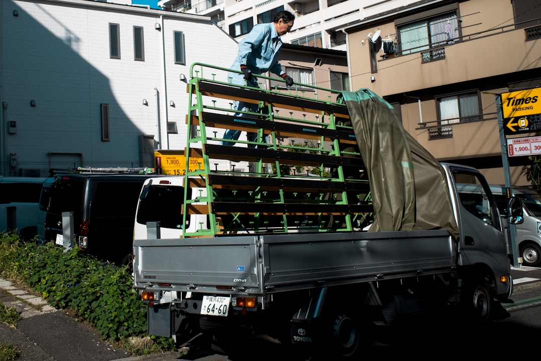 A man standing on the back of a pick up truck
